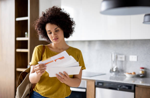istock Woman getting bills in her mail and looking upset 1395273133
