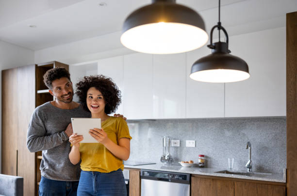 Couple controlling the lights in their house using an automation system