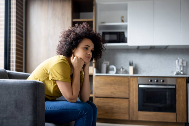 istock Woman at home looking depressed 1395273151