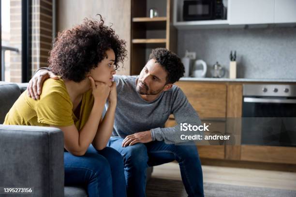 Man Comforting His Girlfriend At Home Stock Photo - Download Image Now - Couple - Relationship, Reconciliation, Consoling