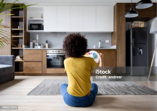 Woman At Home Choosing A Color To Paint The Walls Stock Photo - Download Image Now - Kitchen, Renovation, Home Addition