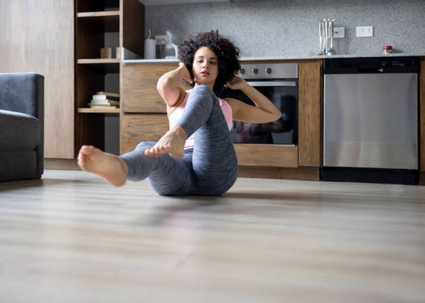 istock Beautiful woman exercising at home 1395273264