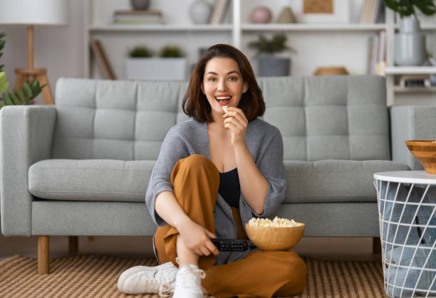 istock woman watching TV 1395275288