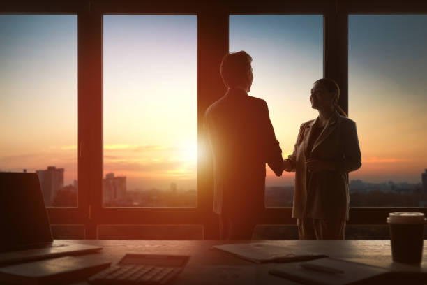 istock man and woman working in the office 1395276762