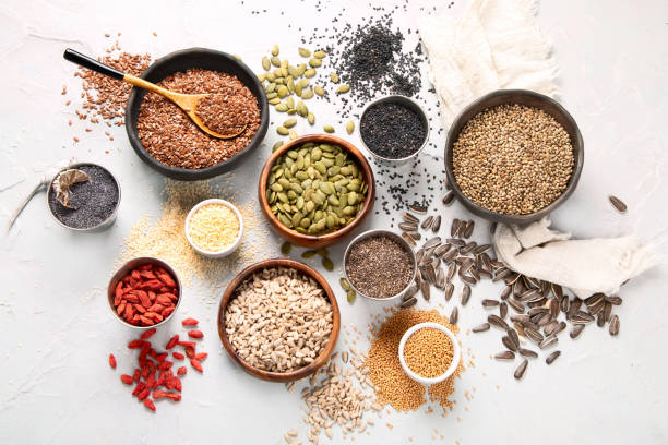 Variety of edible seeds on light background.