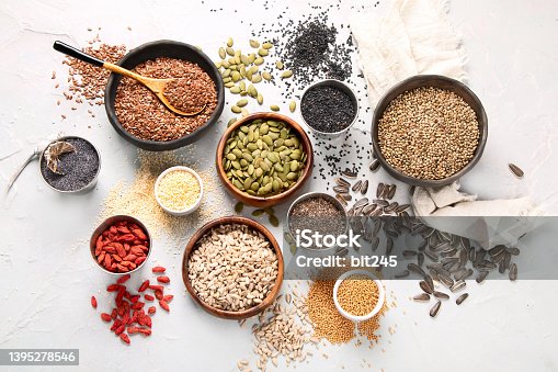 istock Variety of edible seeds on light background. 1395278546