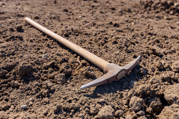 istock Hand pickax hoe is lying on the soil 1395282104