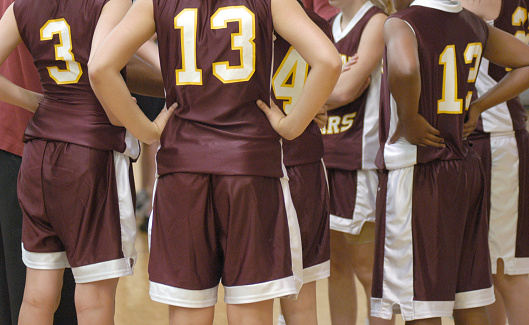 Girls' basketball team in a huddle
