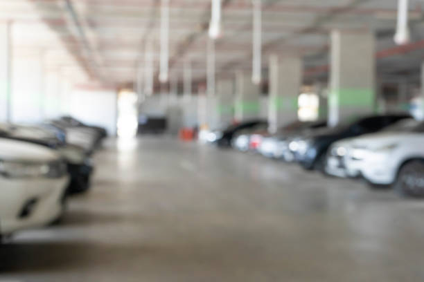 istock Parking garage blur background with blurry building. 1395283780