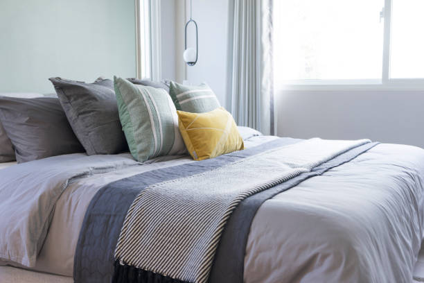istock Yellow and green pillow on bed in modern bedroom. 1395283791