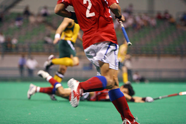 istock Men playing field hockey on turf 139528443