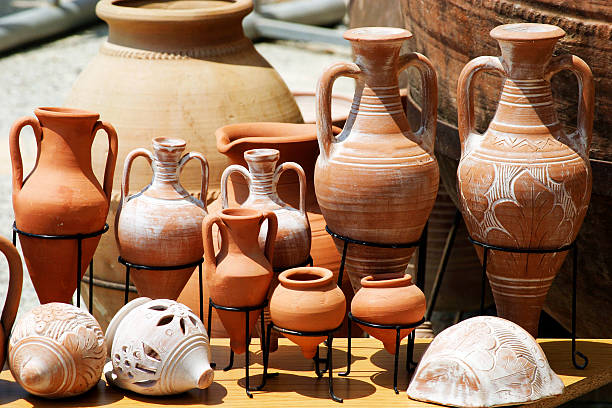 Three rows of clay pots in different shapes and sizes