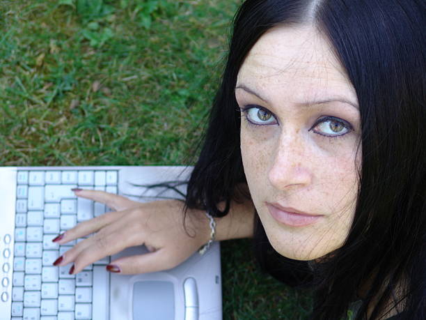 Girl working on her laptop outdoor stock photo