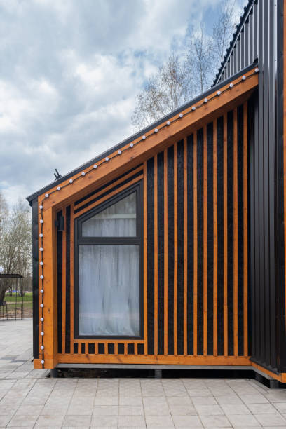 istock Barnhouse facade element. Bright stylish home. panoramic window. Blue sky 1395286372