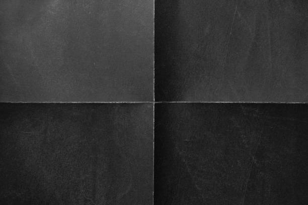 Black paper background with creases Black paper background with creases that separates paper symmetrically into four parts folded stock pictures, royalty-free photos & images