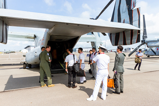 Changi Airport, Singapore - February 12, 2020 : US Soldier Talking With Travellers Near A Aircraft At Singapore Airshow.