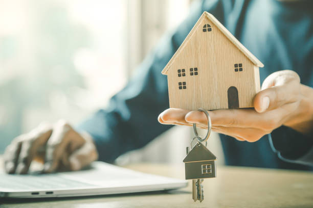 Businessman choosing mini wood house model from model and row of coin money on wood table, selective focus, Planning to buy property. Choose what's the best. A symbol for construction ,ecology, loan concepts. Businessman choosing mini wood house model from model and row of coin money on wood table, selective focus, Planning to buy property. Choose what's the best. A symbol for construction ,ecology, loan concepts. together for yes stock pictures, royalty-free photos & images