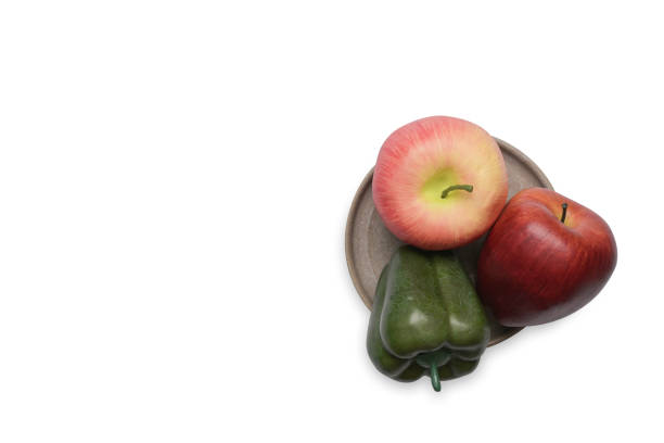 Sweet pepper and red apples isolated on white background.