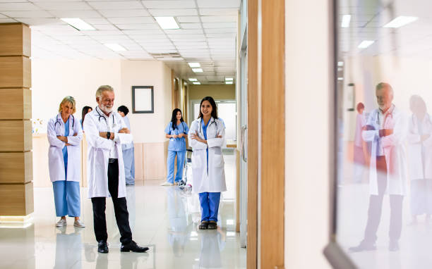 istock Doctors and patients standing, walking at clean comfortable hallway area and reception of modern clinic or hospital. Service, Health and Insurance Concept. 1395292117