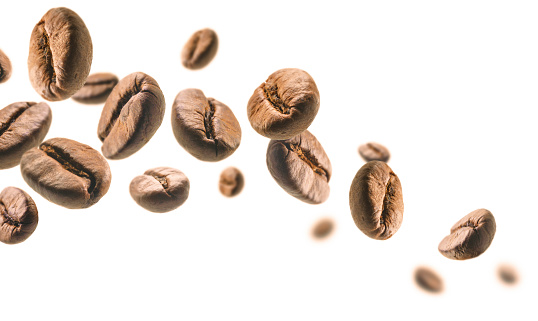Coffee beans levitate on a white background.