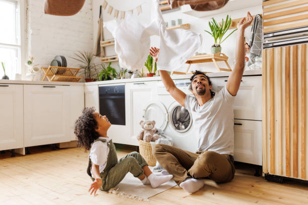 istock Excited father and kid playing with towels 1395294392