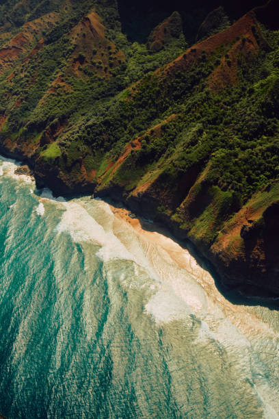 The rugged Na Pali coast and mountain range is part of the lush island of Kauai, Hawaii. The Kalalau Valley hosts the dangerous Kalalau Trail.