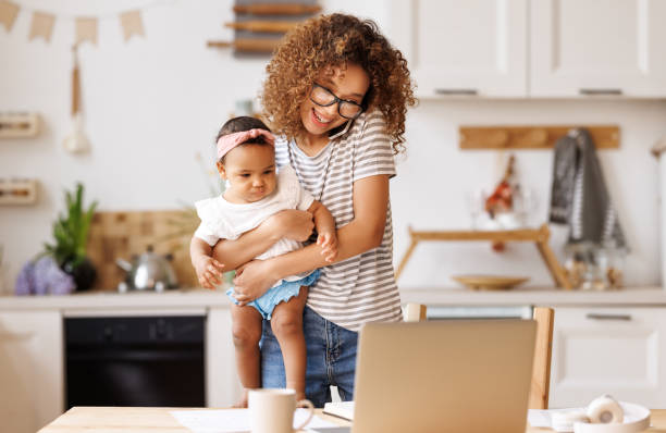 istock Multitasking african american self-employed mother working with baby from home on maternity leave 1395296050