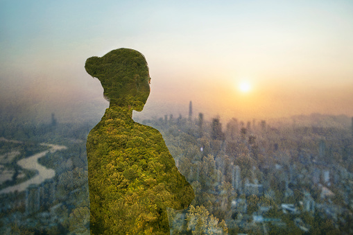 Person standing in contemplation in urban city with nature trees composite, Shenzhen, China