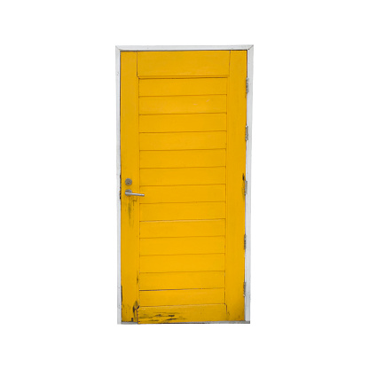 Closed yellow wooden vintage door isolated on white background.