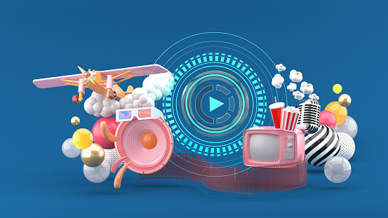 Play icon is surrounded by speakers, TV,Pop corn, microphones and airplanes among colorful balls on a blue background.-3d rendering.