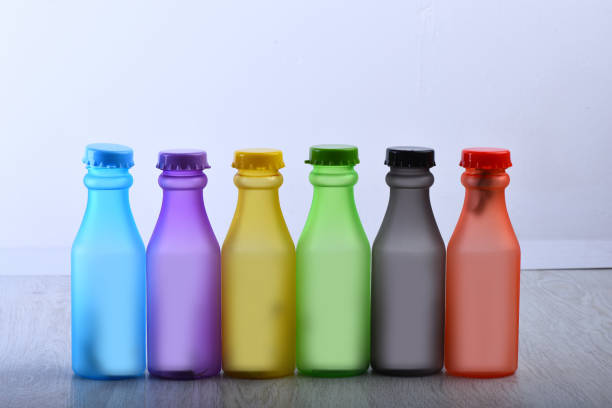 istock Row of colorful soft drinks on grey background background 1395298809