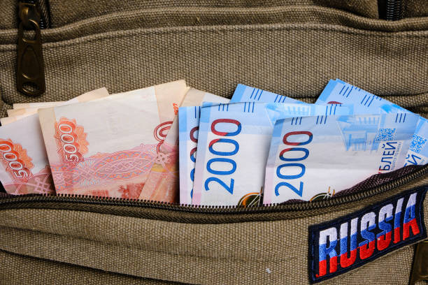 istock Paper banknotes Russian ruble in denominations two and five thousand pocket backpack with inscription Russia. 1395300898