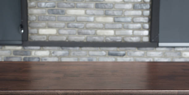 istock Empty wooden table top with lights bokeh on blur restaurant background. 1395301780