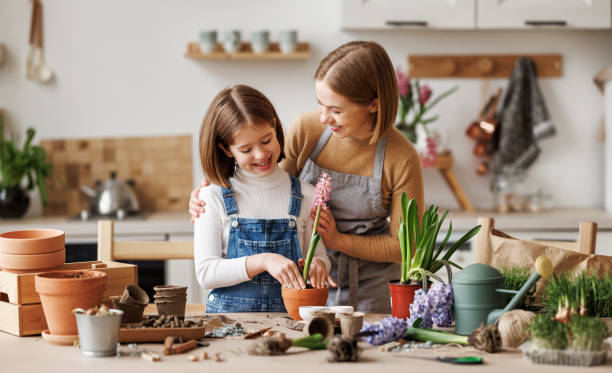 istock Mom and kid doing home gardening together 1395301794