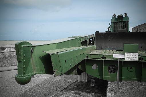 This landscape photo was taken in Europe, in France, in Normandy, towards Arromanches, in Longues sur Mer, in the spring. We see A cannon of the battery of Longues-sur-Mer, under the Sun.