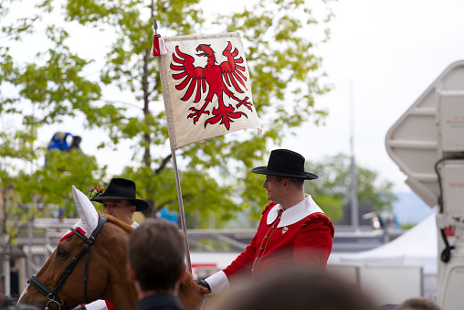 Horse riders of guild at traditional spring festival named Sechseläuten on a rainy spring day. Photo taken April 25th, 2022, Zurich, Switzerland.