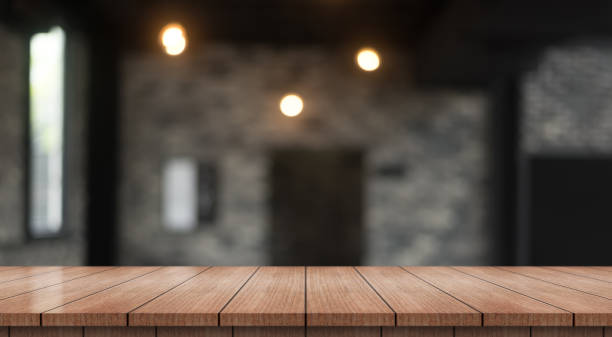 istock Empty wooden table top with lights bokeh on blur restaurant background. 1395302193