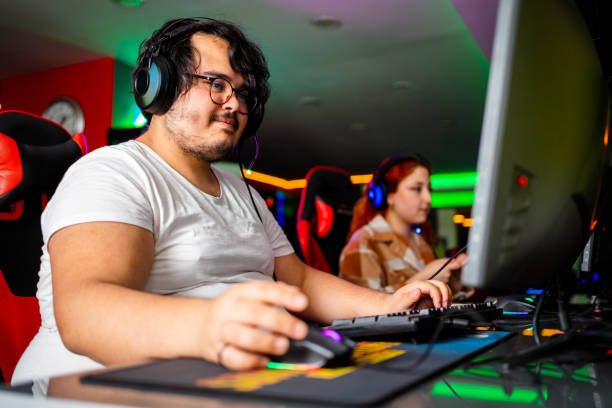 overweight Gamer playing esports overweight Gamer playing esports fat guy playing video games stock pictures, royalty-free photos & images