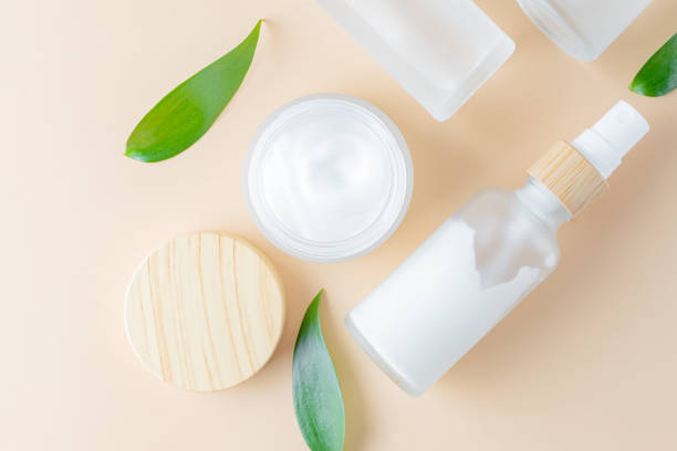 istock Cosmetic container mock-ups. Trendy Background for branding and packaging presentation. Natural skincare beauty product concept. Serum, cream, essence and spray beauty set with green leaves 1395302415