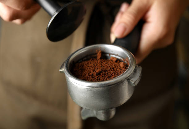 istock Barista making espresso using professional coffee machine, closeup 1395304456