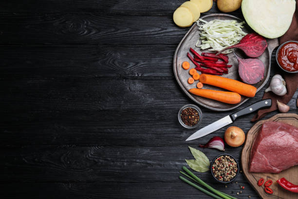 istock Fresh borscht ingredients on black wooden table, flat lay. Space for text 1395304806
