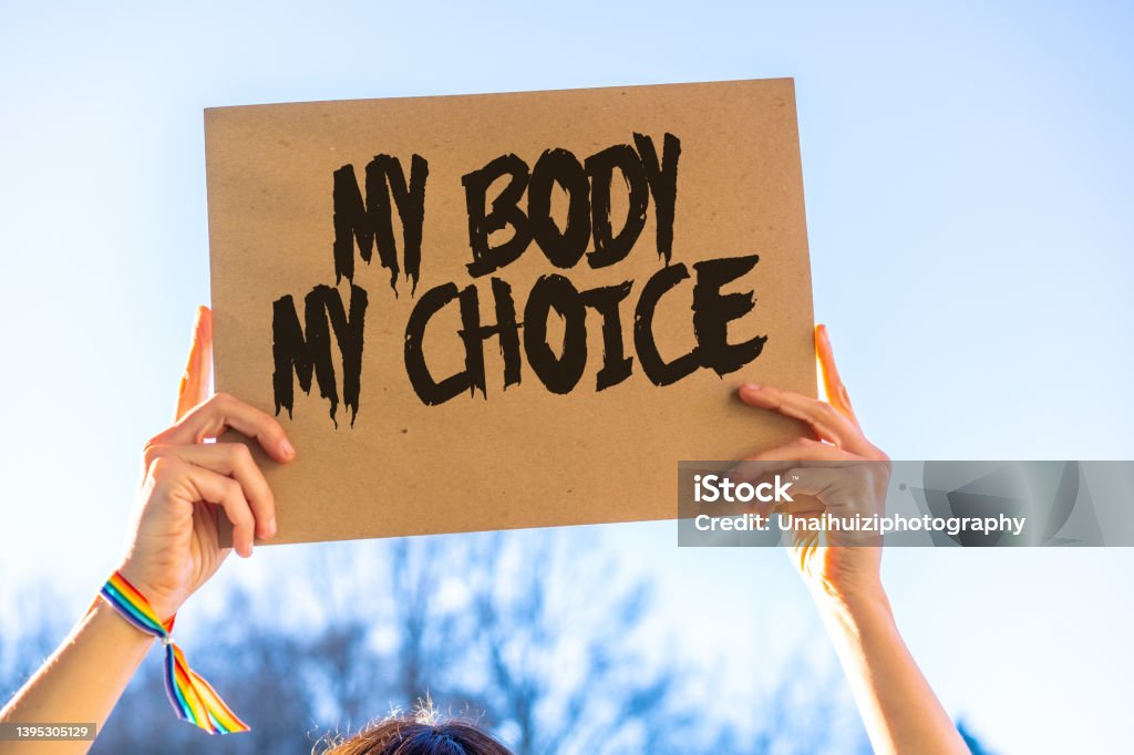 A woman holding a sign in favor of the legalization of abortion. Protest not to make abortion illegal in the united states, pro-choice, pro-life Abortion Stock Photo