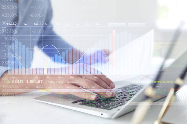 istock Stock exchange. Man using laptop at table and illustration of rating graph 1395305882