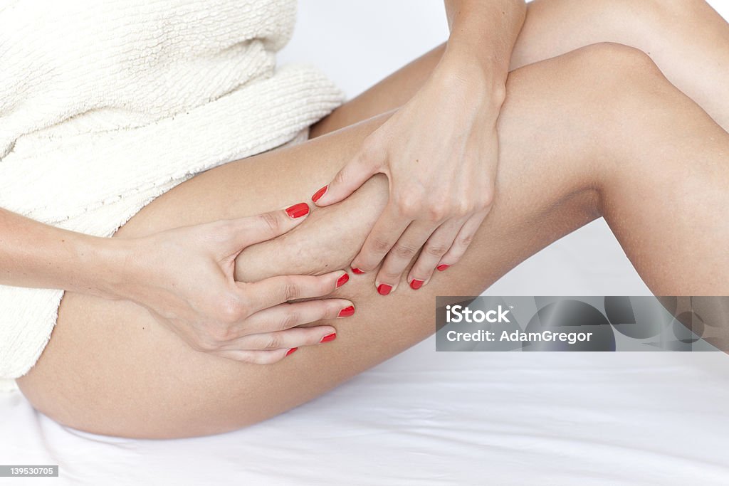 woman checking her legs for cellulite female hand checking for cellulite Cellulite Stock Photo