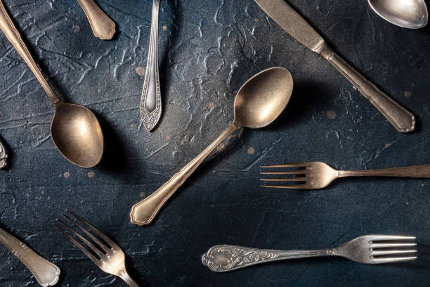 istock Cutlery pattern. Spoons, forks, and knives. Modern tableware on black 1395307178