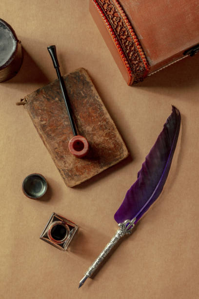 istock Vintage pipe, notebook, a quill pen, and an ink well. Private detective 1395307221