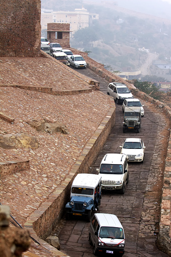 Jaipur, Rajasthan, India - January 3, 2010 :   A posse of cars transporting the crowd of tourists atop the most popular tourist attractions at Jaipur - the Amer Fort or the Amber Palace.