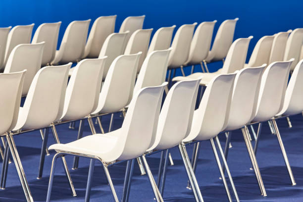 istock Contemporary white plastic chairs in a conference room. Teamwork 1395308566