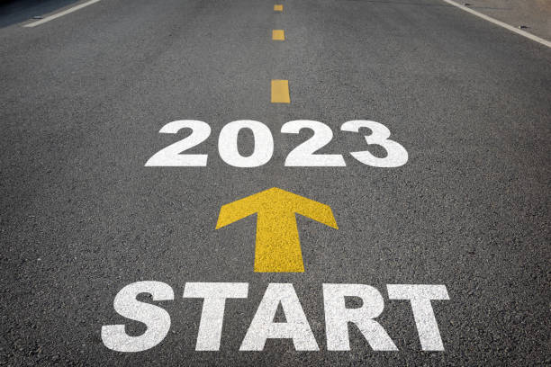 istock Start to 2023 written on the road background with yellow arrow 1395308794