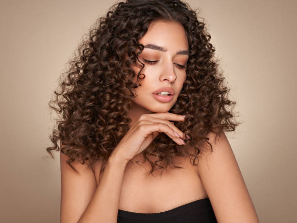 istock Beautiful smiling woman with afro curls 1395309768